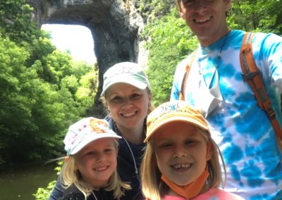 Monte Glanzer with his wife and two daughters together in front of the Natural Bridge.
