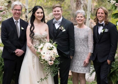Celia Lankford at a wedding, posed with her husband, two sons, and daughter in law.