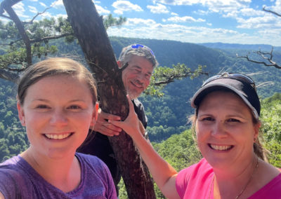 Kendra Stribling, her husband, and her daughter posed together on a hike.